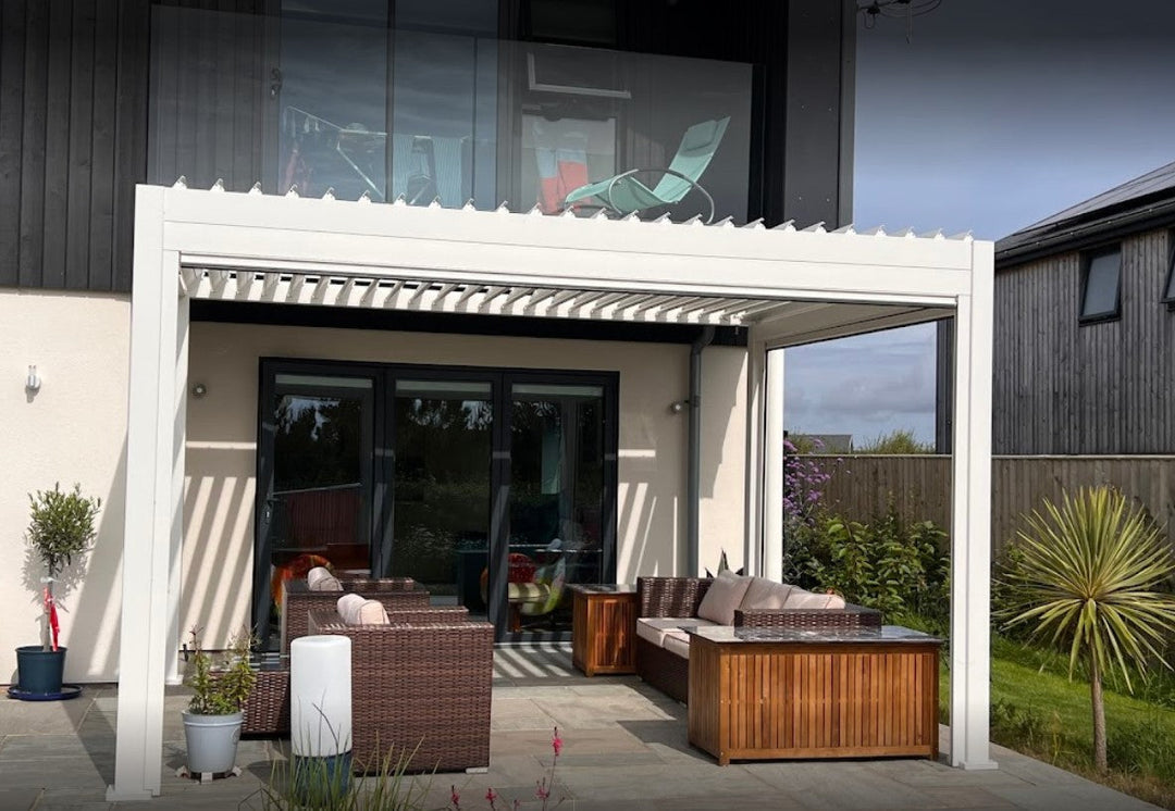 Moder Glass house, with Titan Pebble Aluminium Pergola and garden furniture underneath.