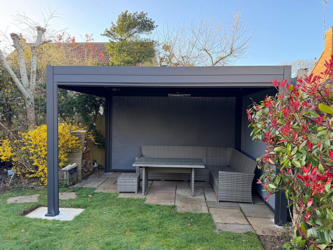 Nova Titan Pergola with privacy screens in back garden in Harrogate Yorkshire with red bush to the right side and nice blue sky.