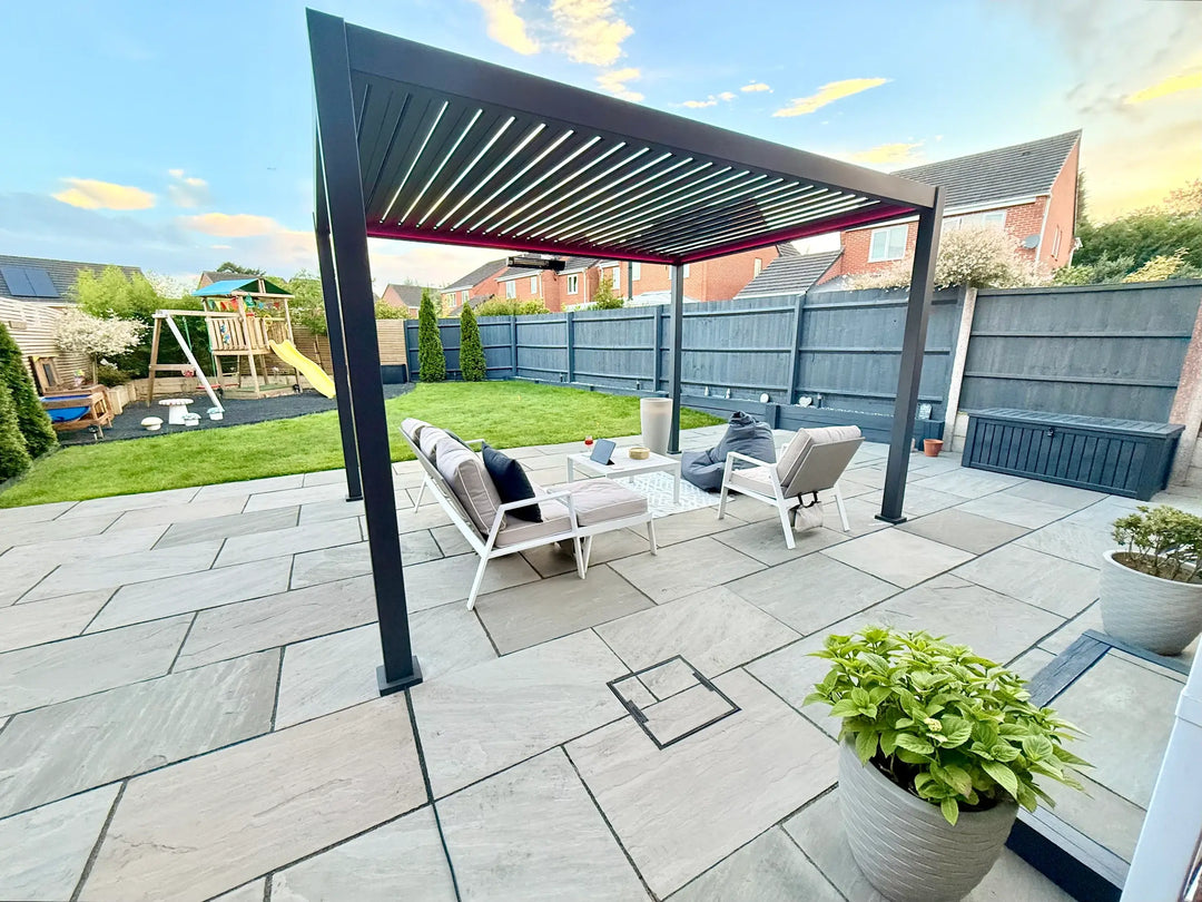 Nova Titan pergola in back garden, on large patio area with grey fence behind