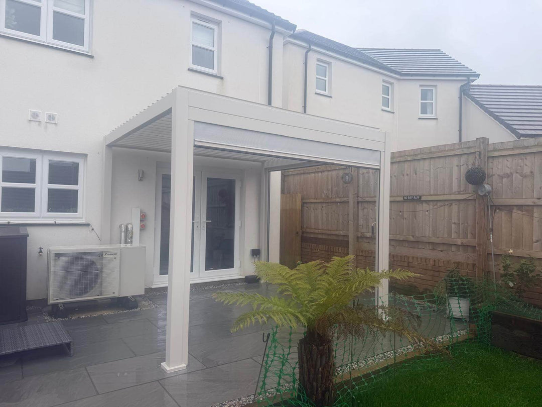 Nova Titan Pebble 3M x 3M Pergola in Yorkshire Hull, on the back of a modern new build house with small palm tree at the front.