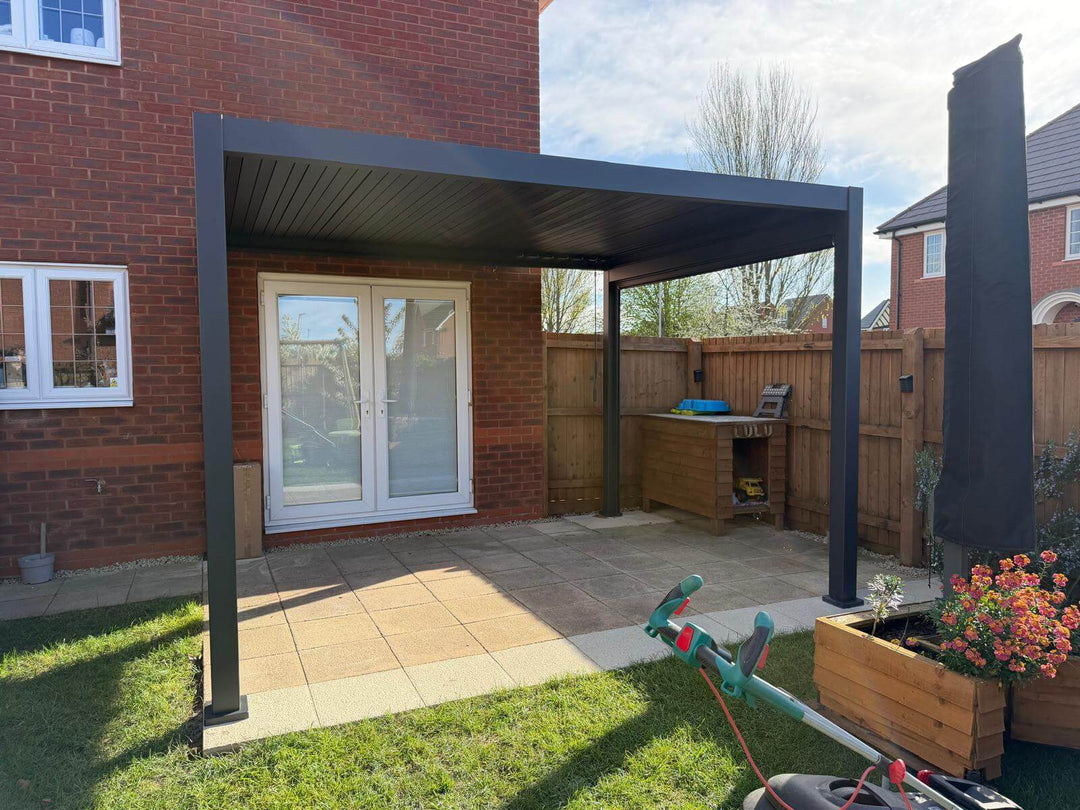 Nova Titan Pergola Installation in Gloucester, Gloucestershire installed by Midland Garden Furniture, bright sunny spring morning with light blue cloudy sky behind.