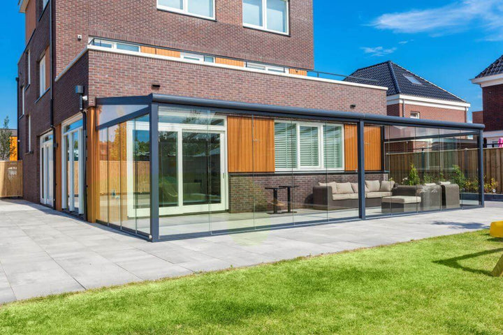 Deponti Bosco garden room with Fiano glazing on sleek modern patio tiles