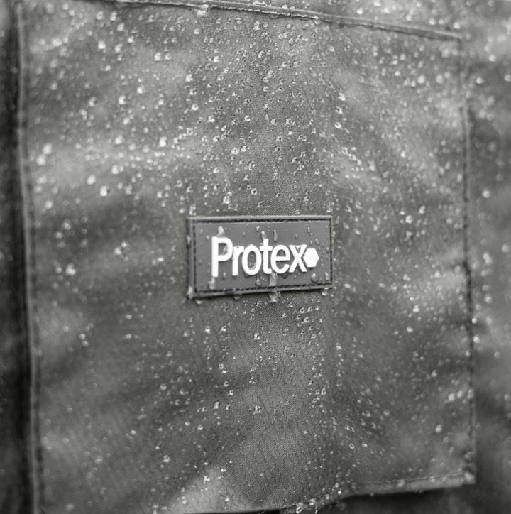 Close-up of a nova garden furniture cover with 'Protex' logo on a rainy day. Water droplets on the Hexgrid cover.