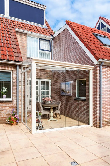 Luxury garden room from Deponti Bosco with full Fiao glazing and sleek patio tiles in cream finish.