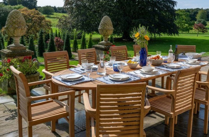 Teak Outdoor dining setup with wooden chairs and table in a garden setting