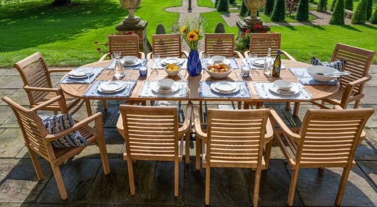 Teak Outdoor dining setup with a table and chairs on a patio