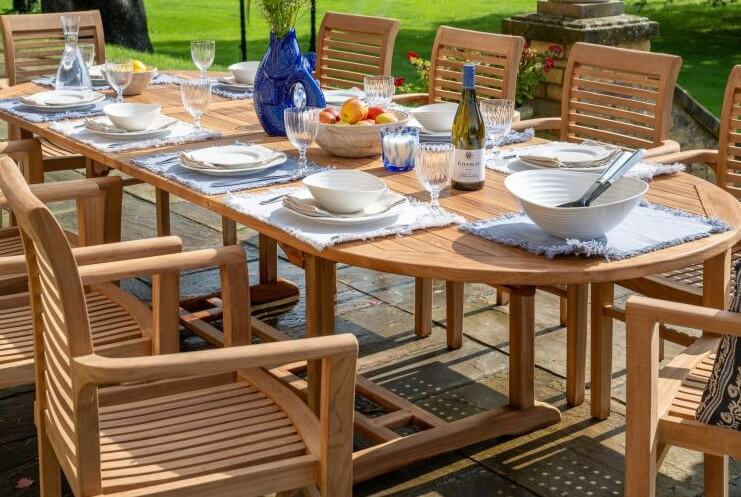 Teak Outdoor dining setup with wooden table and chairs on a patio