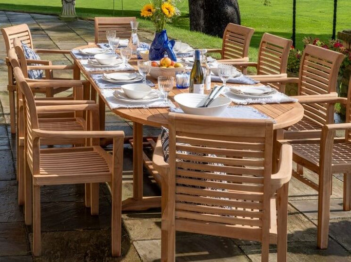 Outdoor teak dining set with wooden table and chairs on a patio