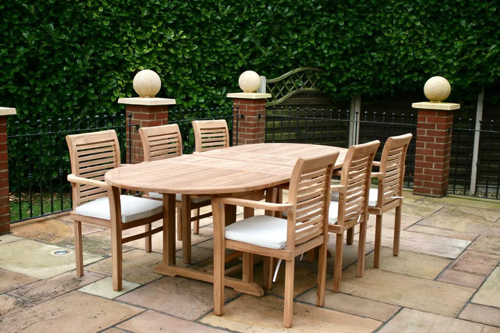 Hanover Teak Wooden outdoor dining set with chairs on a patio