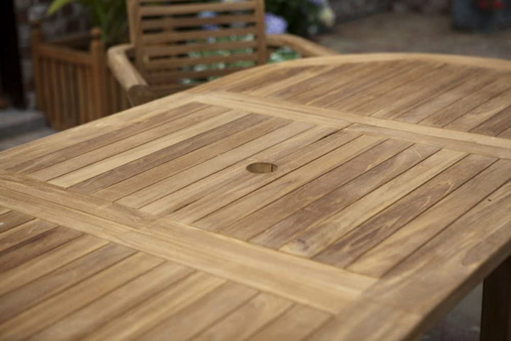 teak Wooden outdoor table with a chair in the background