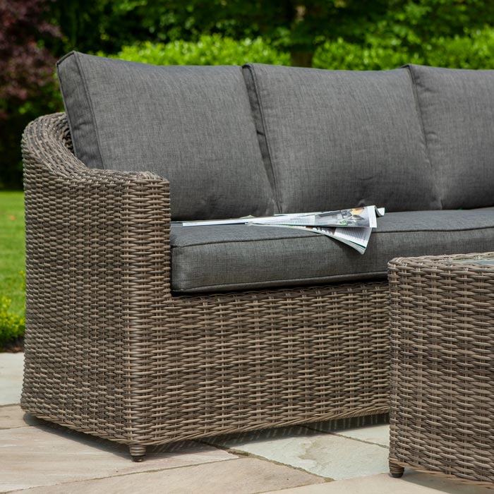 Bunbury Corner Garden Sofa Natural  weave coffee table and sofa end secton in outdoor garden.