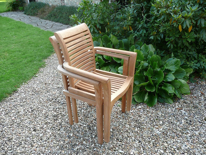Teak Wooden chair on a gravel path with greenery in the background