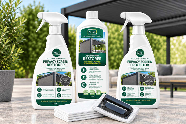 Three bottles of MGF Pergola Privacy Screen Restorer and Protector and Aluminium Restorer are displayed on a patio counter with a cleaning cloth and sponge in the foreground, set against a blurred outdoor background with Pergola at back with green bushes.