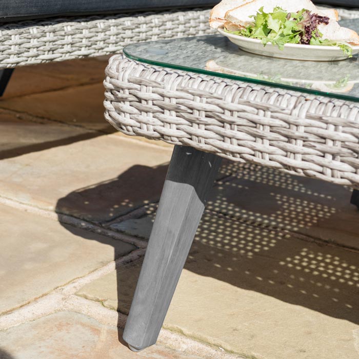 Midland Garden Furniture Heritage Collection Offley Garden furniture set, grey rattan and grey wooden legs on a sand stone patio. Close up image.