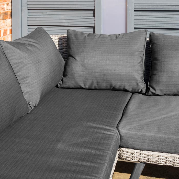 Midland Garden Furniture Heritage Collection Offley Garden furniture set, grey rattan and grey wooden legs on a sand stone patio. Close up image of the dark grey cushions