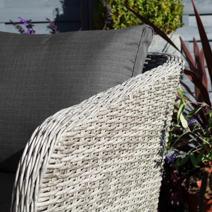 Midland Garden Furniture Heritage Collection Offley Garden furniture set, grey rattan and grey wooden legs on a sand stone patio. Close up image of sofa rattan corner.