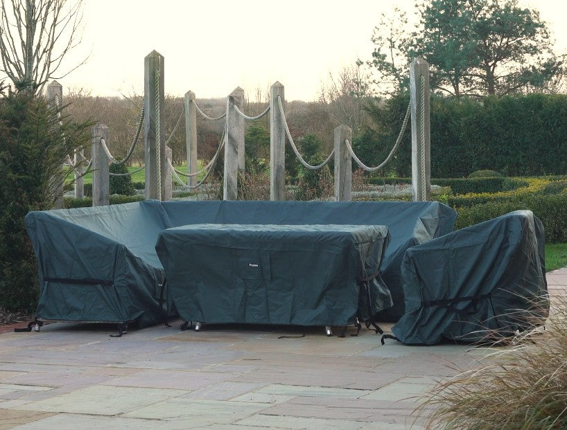 Green outdoor Protex furniture covers on a patio with a garden background and stone slabs