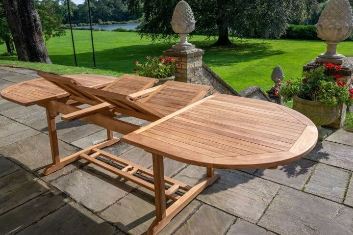 teak Wooden outdoor table with a folding leaf on a patio