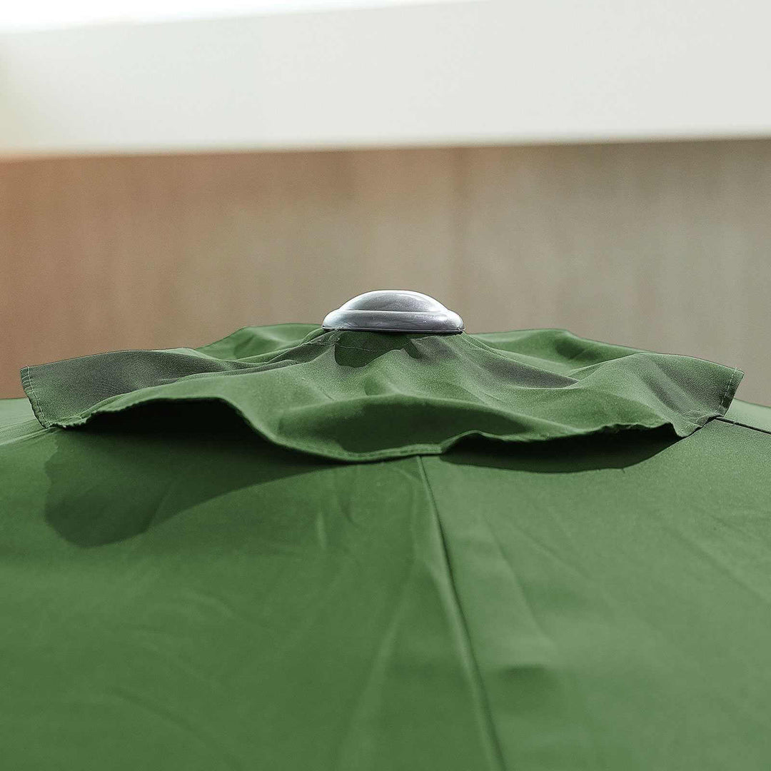 Close-up of a NOVA Outdoor living green parasol with a metallic handle against a beige background