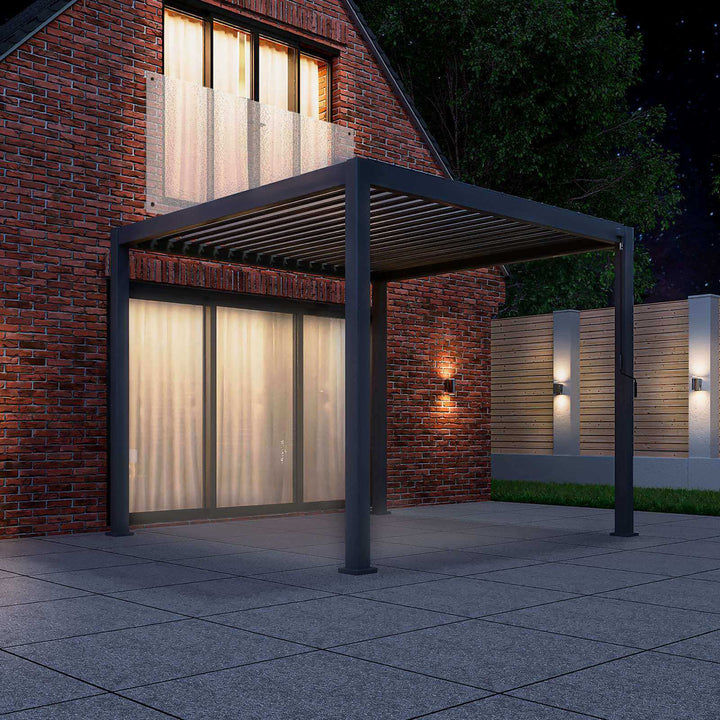 Grey Titan Pergola 3M x 3M against house in ark night, with lights lighting uo