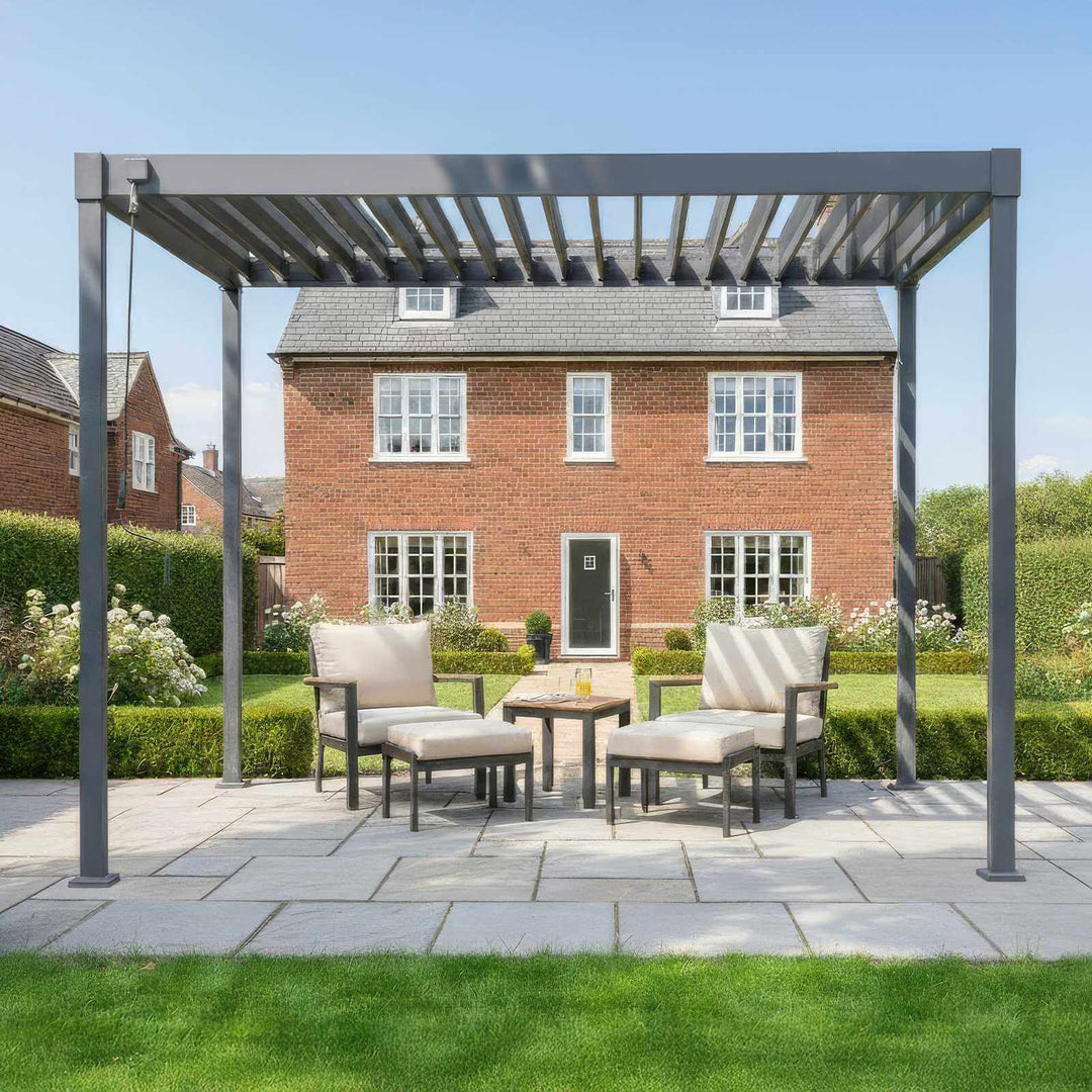 Patio area with a Nova Luna pergola, outdoor furniture, and a house in the background