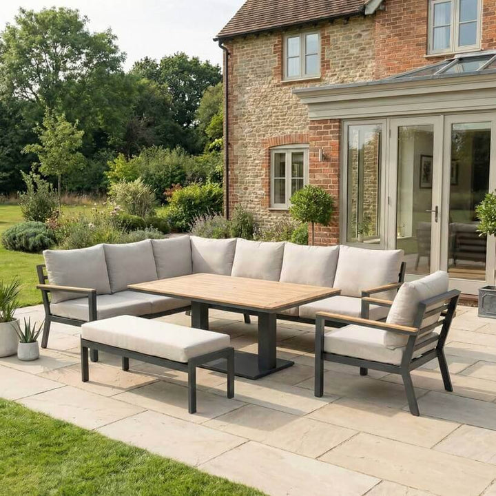 Nova Heidi outdoor living furniture set Midland Garden Furniture with in front of a Cotswold house with plants at the back. corner sofa set. 