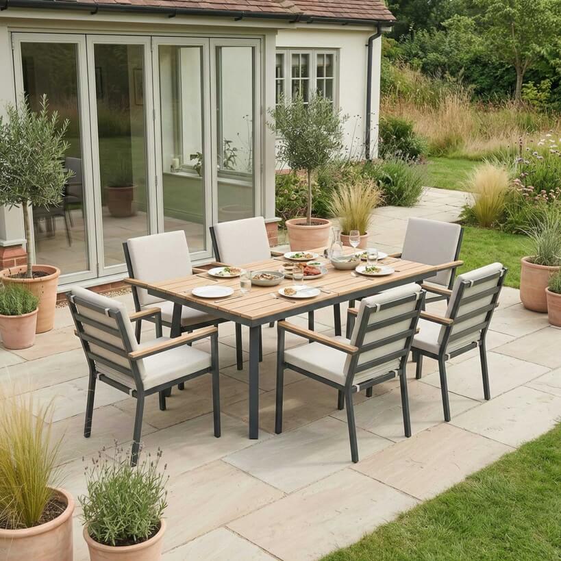 Nova Heidi outdoor living furniture set Midland Garden Furniture with in front of a Cotswold house with plants at the back. 6 seater set. 