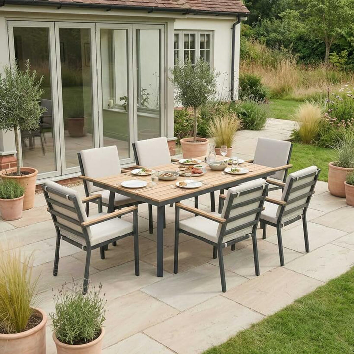 Nova Heidi outdoor living furniture set Midland Garden Furniture with in front of a Cotswold house with plants at the back. 6 seater set. 