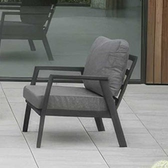 Phoenix Nova Outdoor Living modern Grey outdoor arm chair with a cushion on a tiled floor.