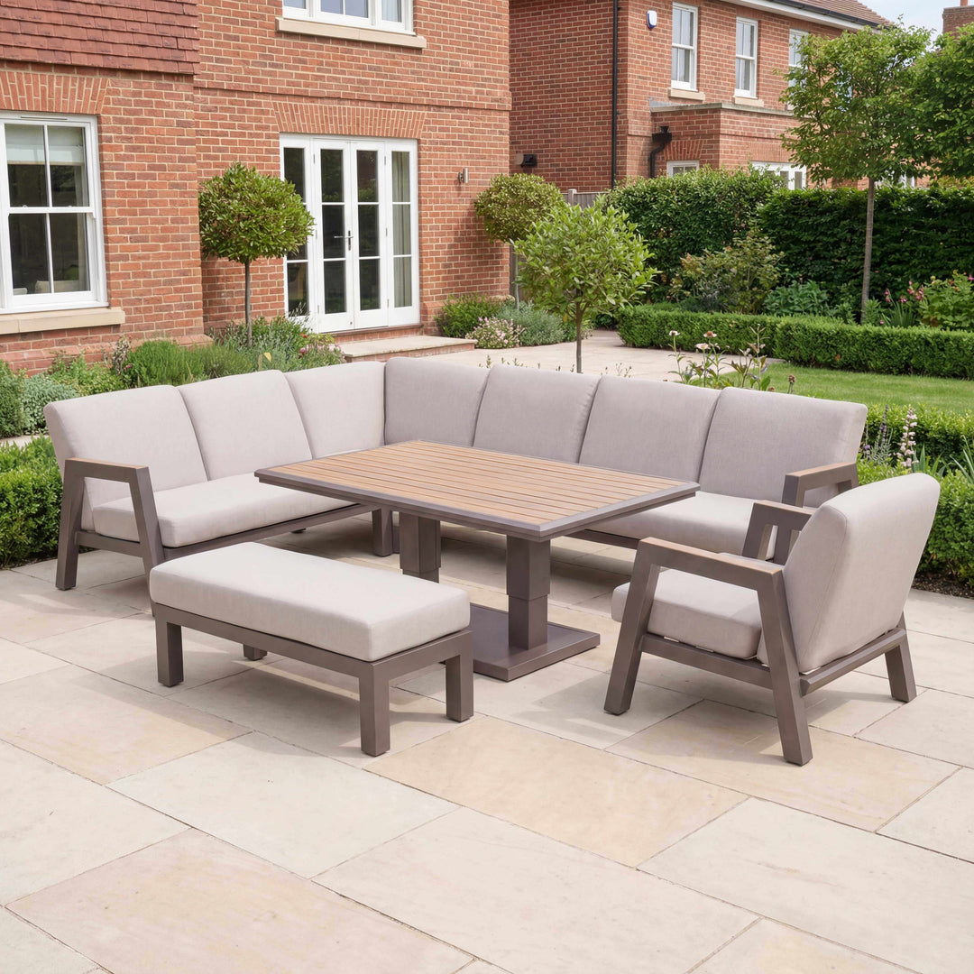 Nova Hunter Sofa Set Midland Garden Furniture. set in a new modern garden, with trees and shrubs at back of big house.