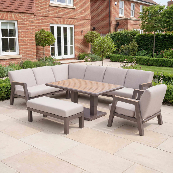 Nova Hunter Sofa Set Midland Garden Furniture. set in a new modern garden, with trees and shrubs at back of big house.