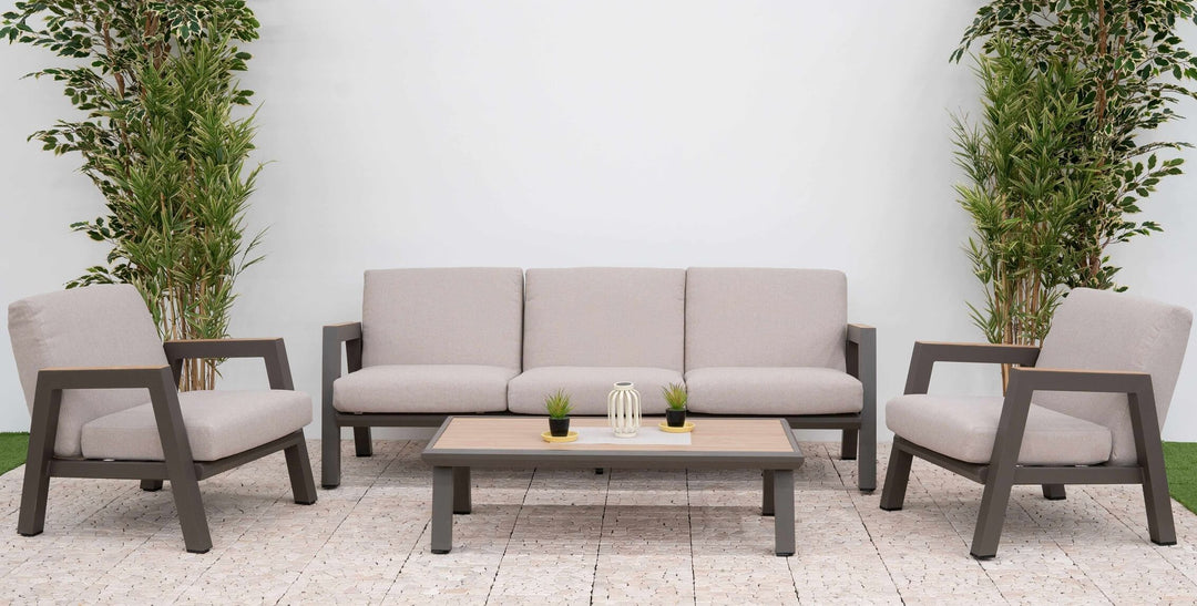 Hunter Outdoor furniture sofa set with sofa, 2 x chairs, and table with wooden top on a cobbled patio