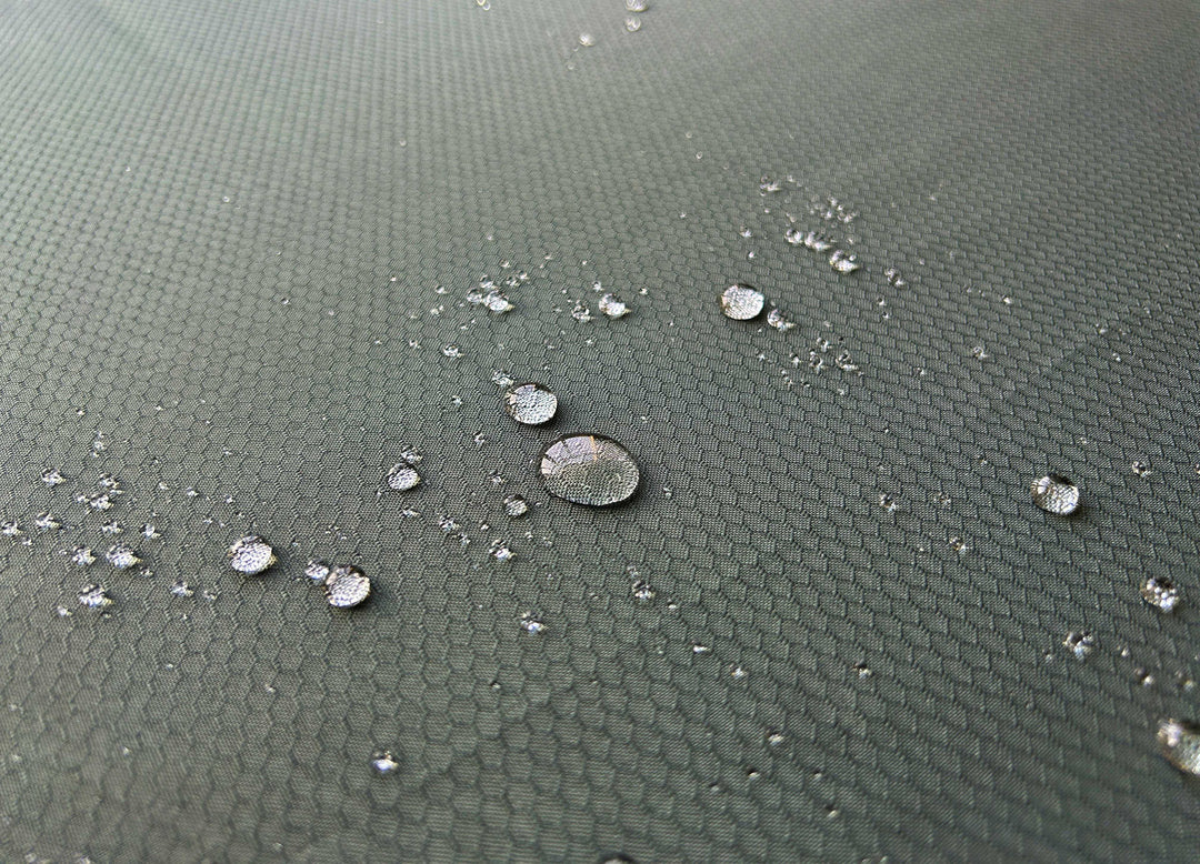 Water droplets on a Protex textured garden furniture cover from Nova Green Grey finish with Hexagon shapes in material 