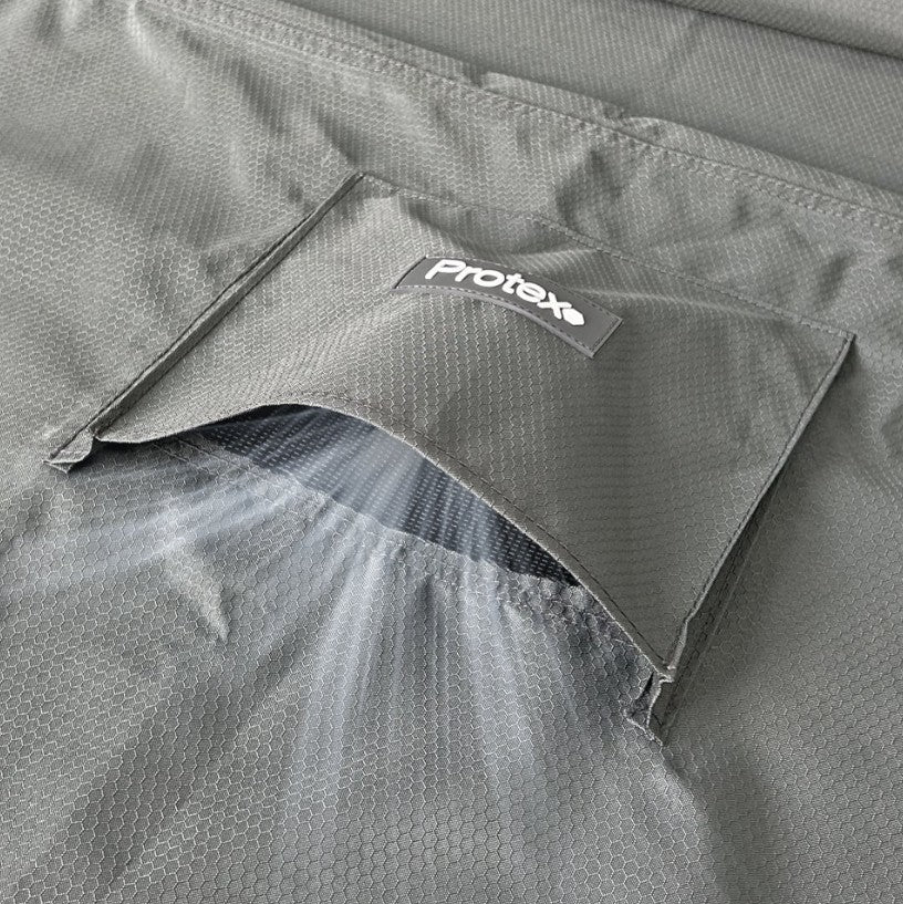 Grey Nova garden furniture cover fabric  with a Protex logo on a close-up of a product and wind showing can get through to breath.