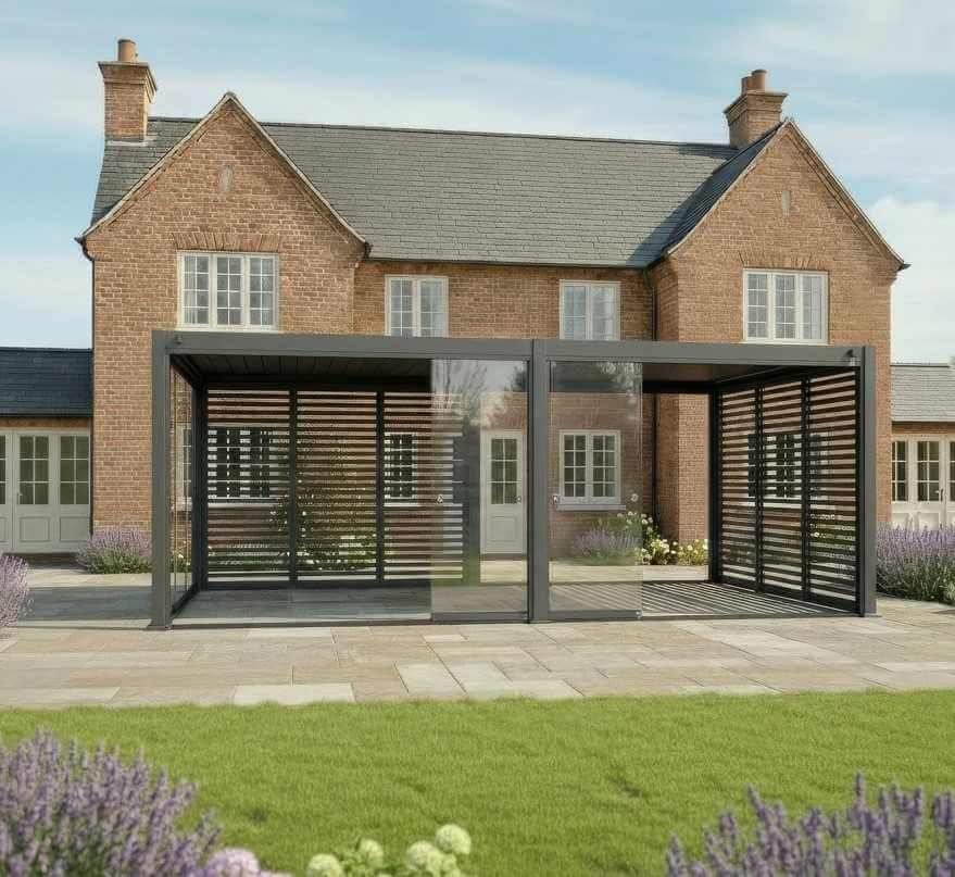 Nova Titan 6M x 3M Pergola with glass doors in grey in front of a brick house cottage style. with glass doors open on sunny day.