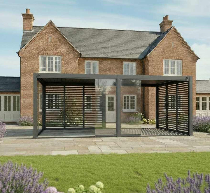 Nova Titan 6M x 3M Pergola with glass doors in grey in front of a brick house cottage style. with glass doors open on sunny day.