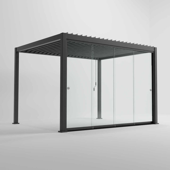 Nova Titan Pergola with glass sliding doors around the sides, with adjustable louvered roof. in anthracite grey with winder handle in pure white room. Image at a right angle with doors closed 4M x 3M