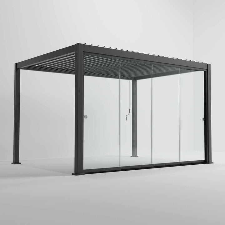 Nova Titan Pergola with glass sliding doors around the sides, with adjustable louvered roof. in anthracite grey with winder handle in pure white room. Image at a right angle with doors closed 4M x 3M Pergola.