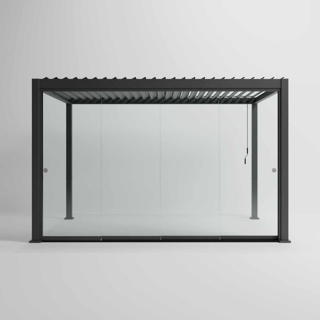 Nova Titan Pergola with glass sliding doors around the sides, with adjustable louvered roof. in anthracite grey with winder handle in pure white room. Front on shot angle. 4M x 3M