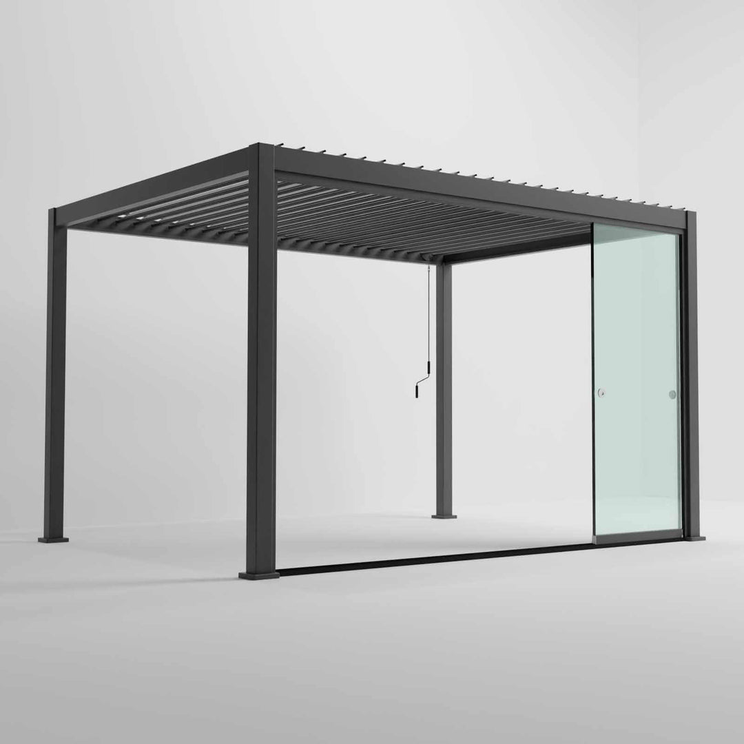 Nova Titan Pergola with glass sliding doors around the sides, with adjustable louvered roof. in anthracite grey with winder handle in pure white room. Image at a right angle with doors slid open. 4M x 3M Titan Pergola.