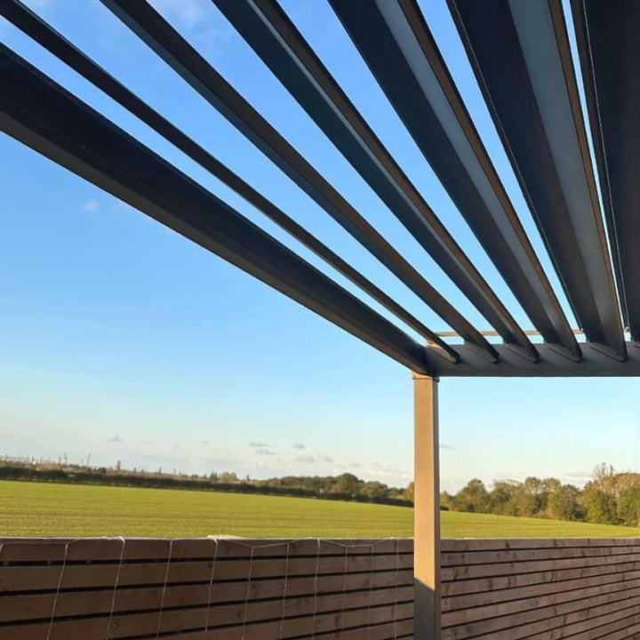 Outdoor Nova Luna pergola with a view of a field and blue sky