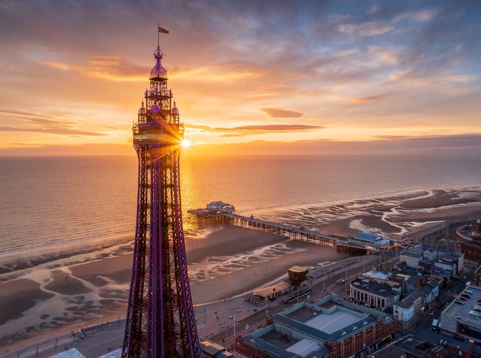 Pergola Installation Lancashire, depicted by the Blackpool Tower at sunset with a beach and pier in the background