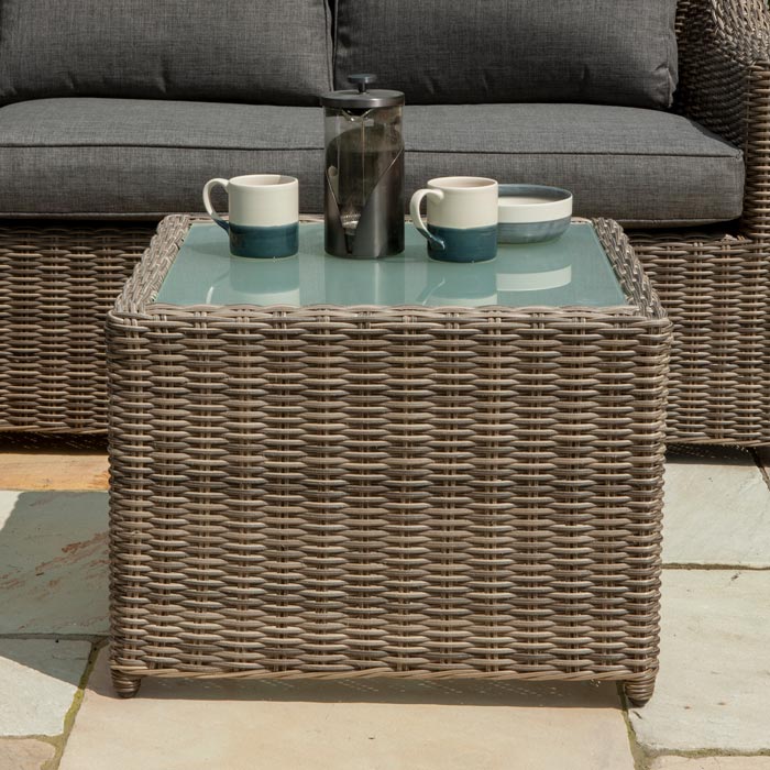 Bunbury Corner Garden Sofa Natural  weave coffee table in outdoor garden.