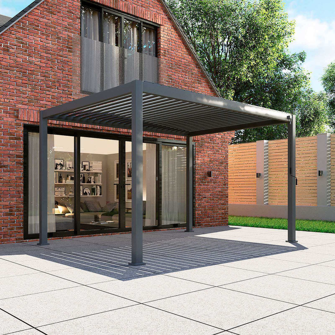 Nova Titan Pergola Grey 3.6M x 3M against brick wall with patio doors opening under, on new clean stone slabs.